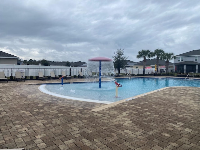 community pool featuring fence