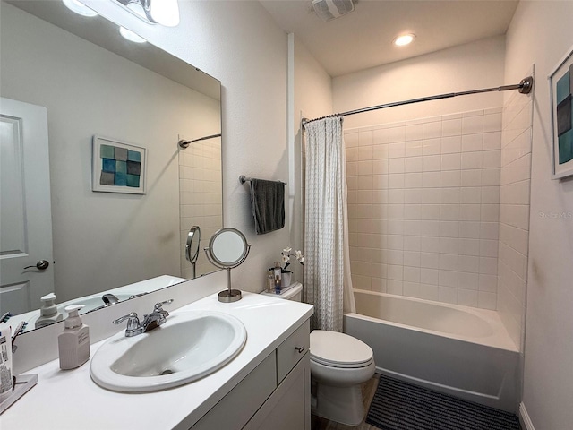 bathroom with vanity, shower / tub combo, toilet, and visible vents