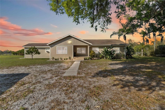 ranch-style home with a yard