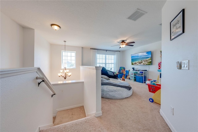 interior space with visible vents, baseboards, a textured ceiling, and carpet flooring