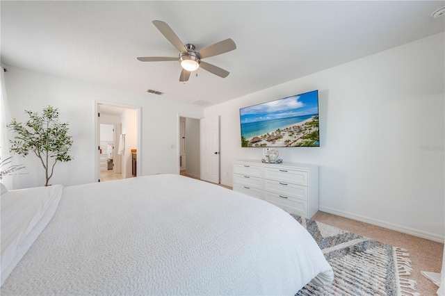 bedroom featuring visible vents, light carpet, ensuite bath, baseboards, and ceiling fan