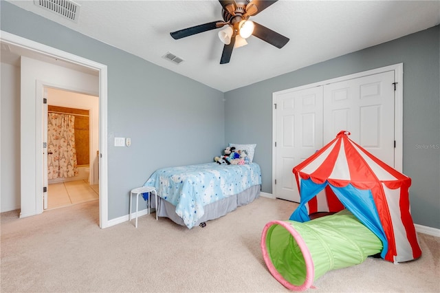 bedroom featuring carpet flooring, baseboards, visible vents, and a closet