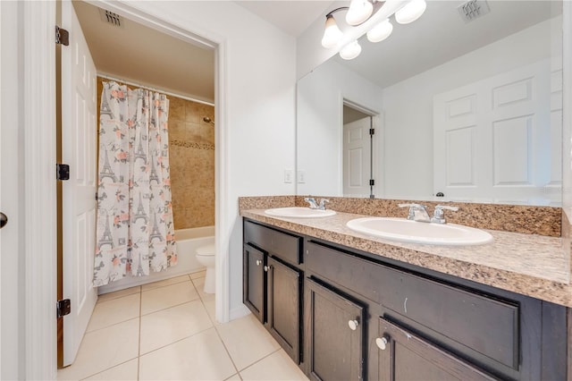 bathroom featuring tile patterned floors, visible vents, double vanity, and a sink