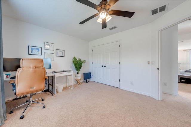 carpeted office featuring a ceiling fan, visible vents, and baseboards