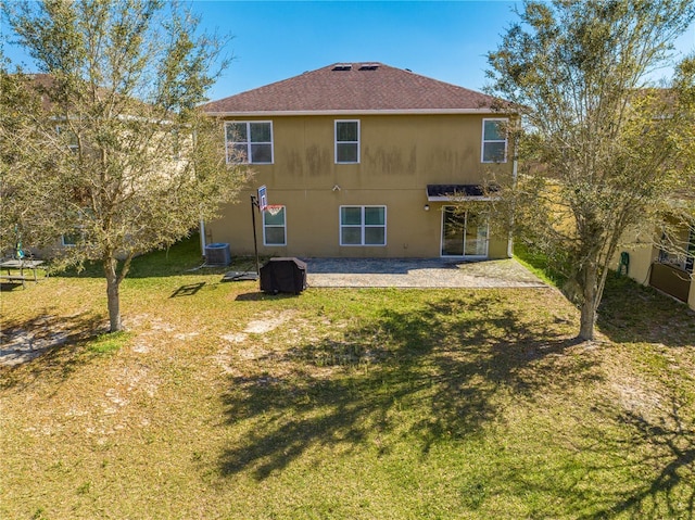 back of house featuring a patio area, a lawn, and central AC