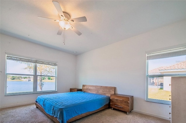 bedroom with baseboards, light colored carpet, and a ceiling fan