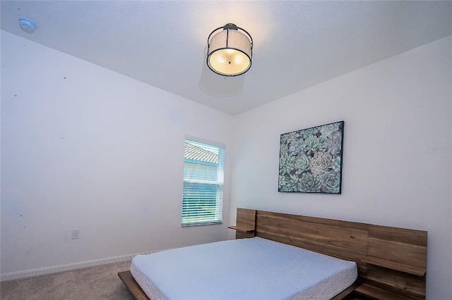 carpeted bedroom featuring baseboards