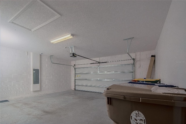 garage with electric panel, concrete block wall, and a garage door opener