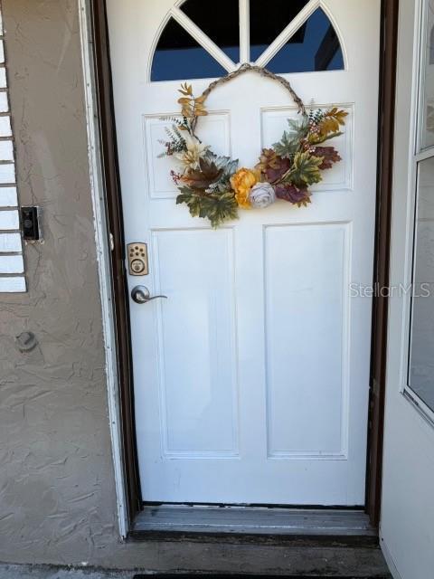 entrance to property featuring stucco siding