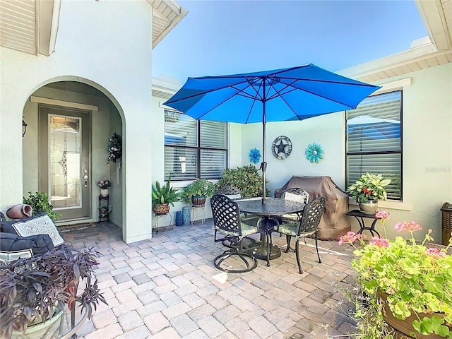 view of patio / terrace featuring outdoor dining area and a grill