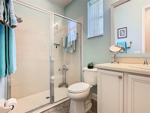 full bathroom with vanity, a shower stall, and toilet