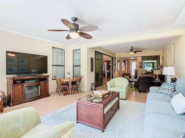 living area featuring wood finished floors and a ceiling fan