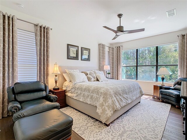 bedroom featuring visible vents, wood finished floors, and a ceiling fan
