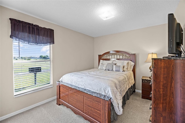 bedroom with light carpet, multiple windows, and baseboards