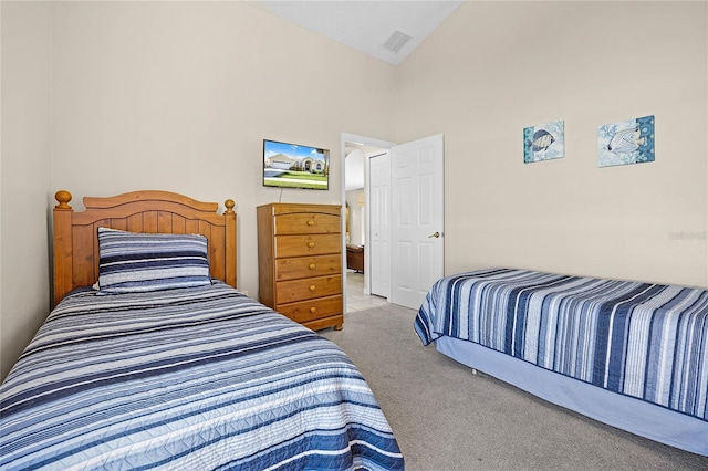 bedroom featuring visible vents, carpet flooring, and high vaulted ceiling