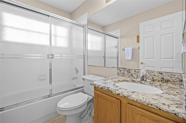 full bathroom featuring enclosed tub / shower combo, toilet, and vanity