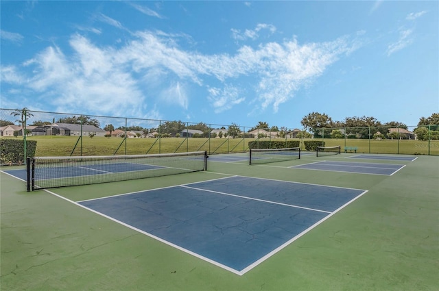 view of tennis court featuring fence