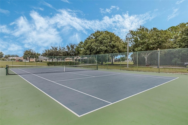 view of sport court featuring fence