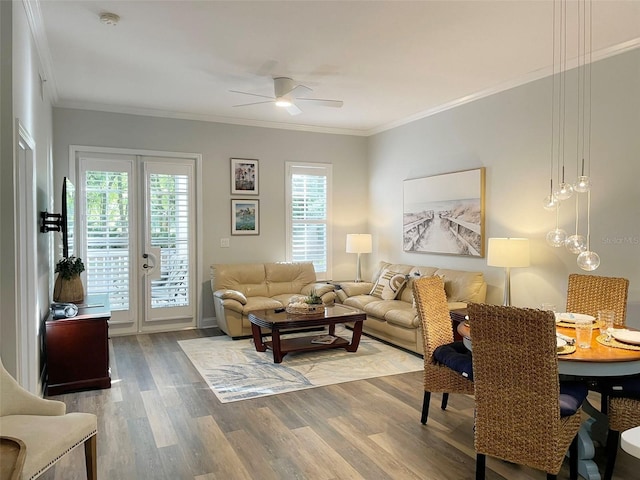 living room featuring a ceiling fan, crown molding, wood finished floors, and french doors