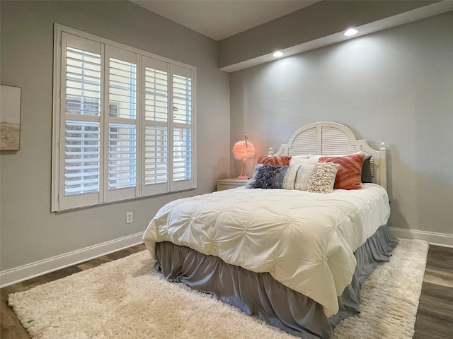 bedroom with recessed lighting, baseboards, and wood finished floors