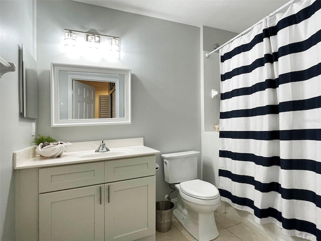 bathroom with a shower with curtain, tile patterned floors, toilet, and vanity