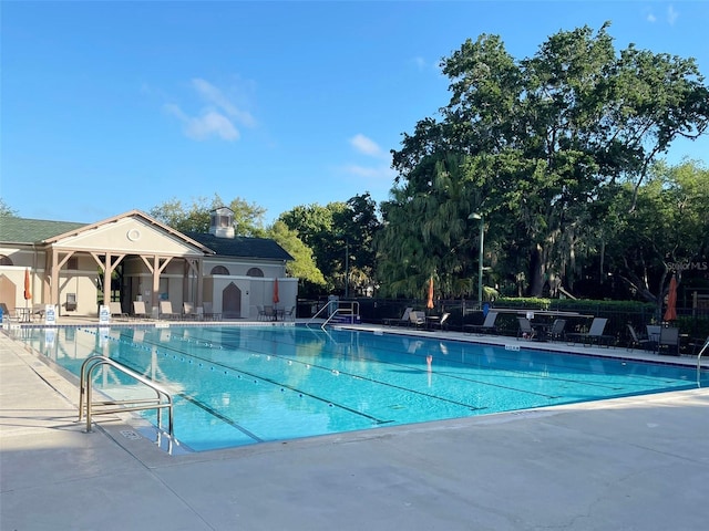 pool featuring a patio and fence