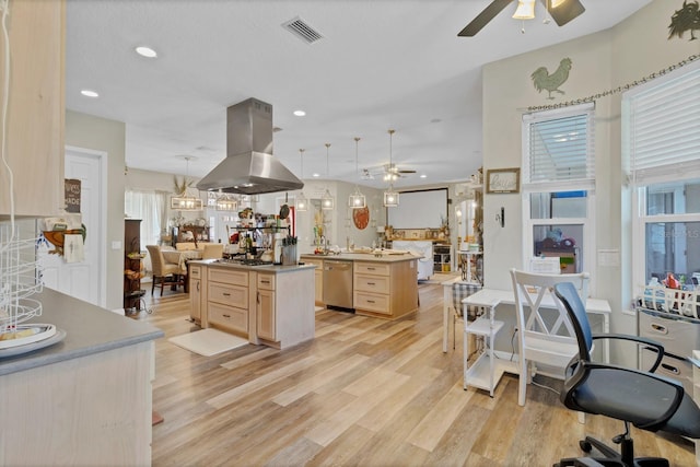 kitchen featuring visible vents, light brown cabinets, light wood-style flooring, island exhaust hood, and stainless steel appliances