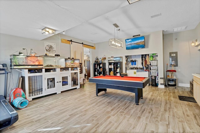 rec room with light wood-type flooring, a barn door, visible vents, and billiards