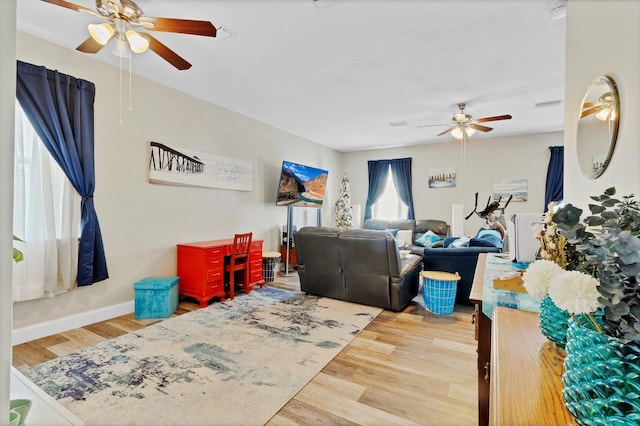 interior space with wood finished floors, baseboards, and ceiling fan