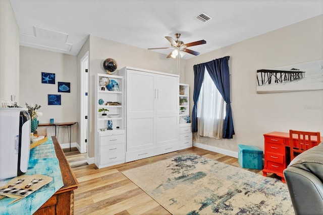 interior space with visible vents, baseboards, light wood-style floors, and attic access