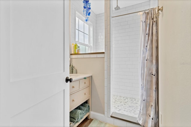 full bathroom with a shower stall and vanity