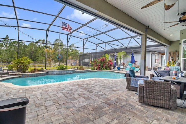 pool featuring glass enclosure, a patio, and ceiling fan