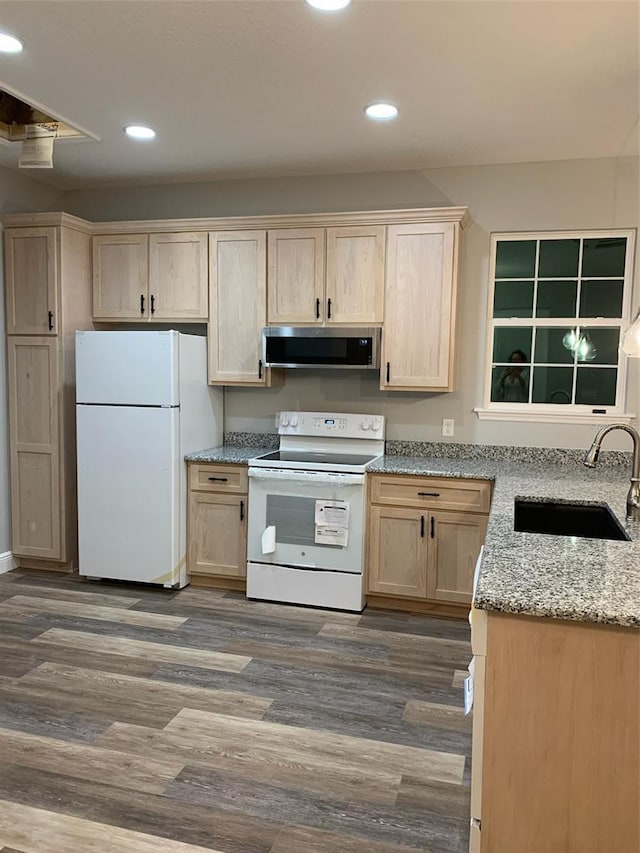 kitchen with dark wood-type flooring, light brown cabinets, a sink, ventilation hood, and white appliances