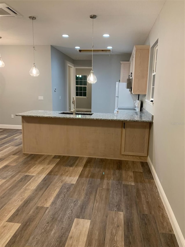 kitchen featuring a sink, baseboards, and dark wood-style flooring