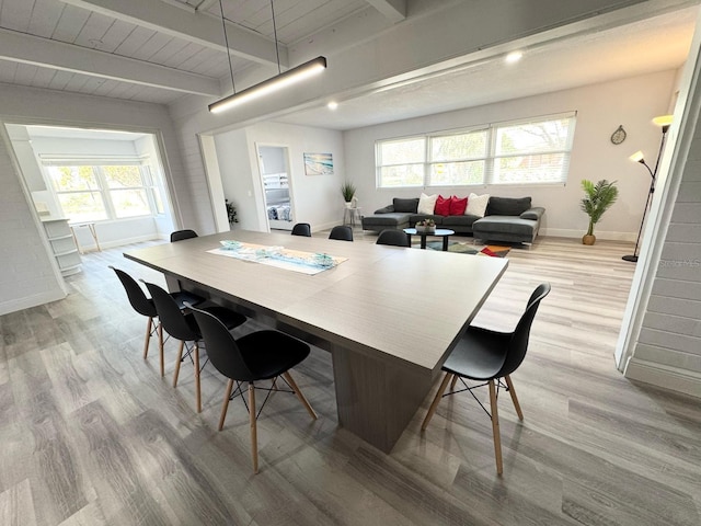 kitchen featuring a wealth of natural light, light wood-type flooring, and beamed ceiling