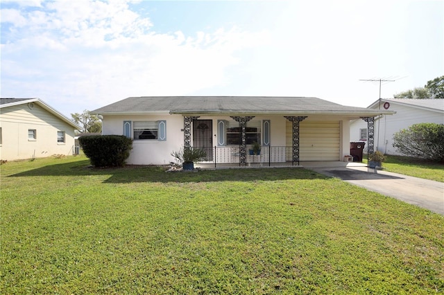 view of front of property featuring concrete driveway, a front yard, covered porch, stucco siding, and an attached garage