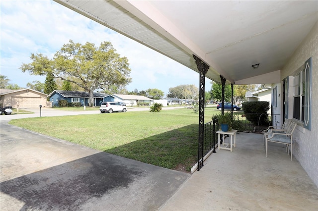 view of yard featuring a porch and a residential view