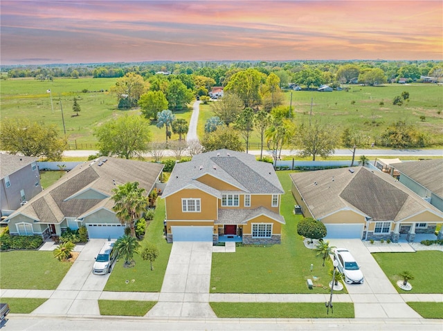 aerial view at dusk featuring a residential view