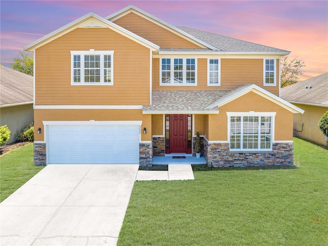 view of front facade featuring a front lawn, concrete driveway, stucco siding, stone siding, and an attached garage