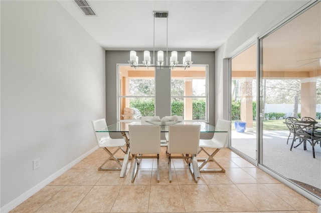 tiled dining area featuring visible vents, baseboards, and an inviting chandelier