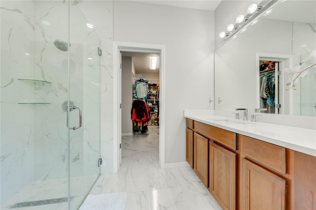 bathroom featuring a marble finish shower, a spacious closet, baseboards, marble finish floor, and vanity