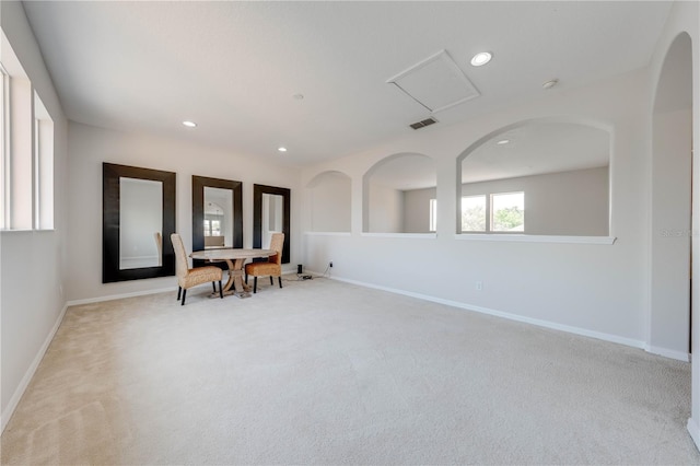 interior space with light carpet, recessed lighting, and baseboards