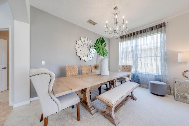 dining area with baseboards, light colored carpet, visible vents, and a chandelier