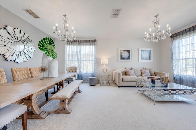 living room featuring carpet flooring, a notable chandelier, and visible vents