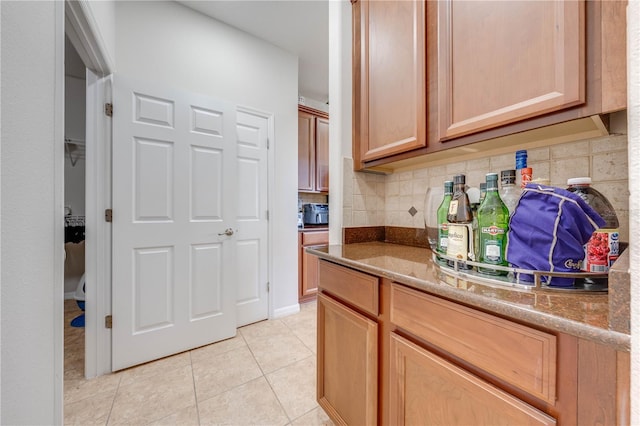 kitchen featuring decorative backsplash and light tile patterned flooring