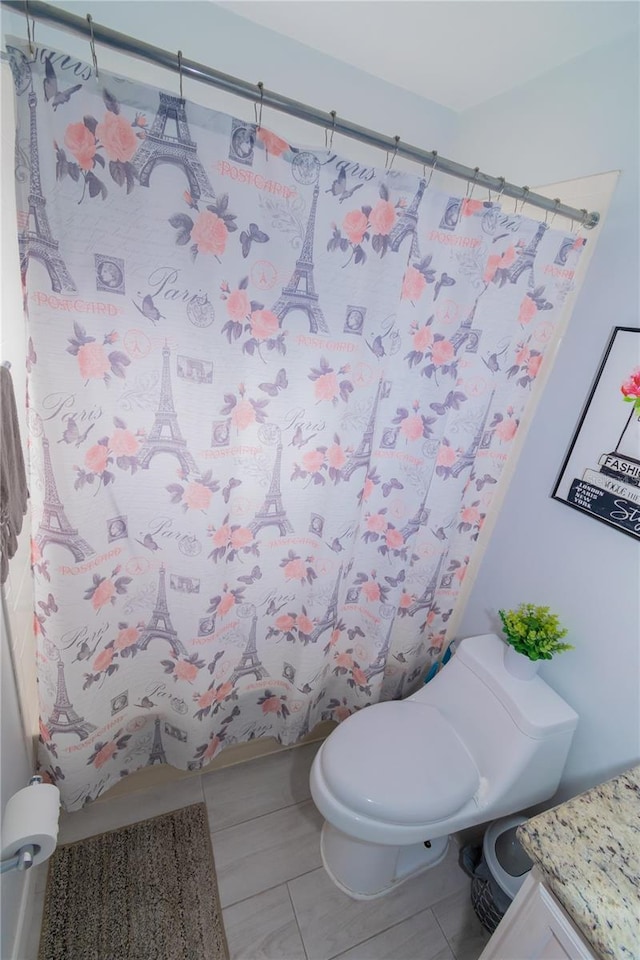 bathroom with vanity, tile patterned floors, toilet, and a shower with curtain