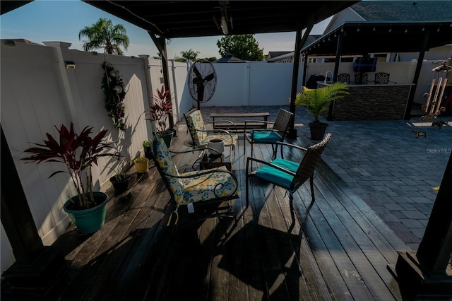 wooden terrace featuring a fenced backyard