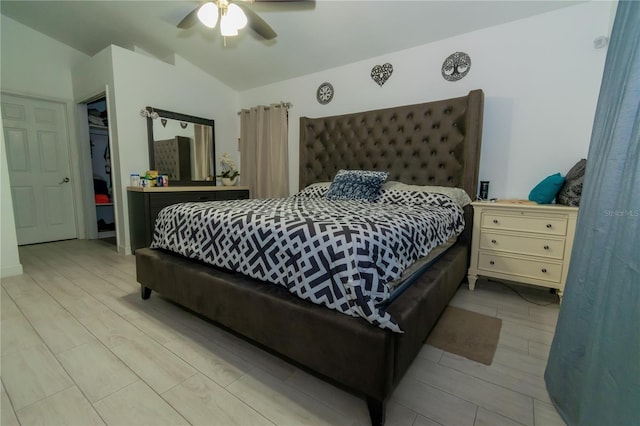 bedroom featuring lofted ceiling, light wood-type flooring, and ceiling fan