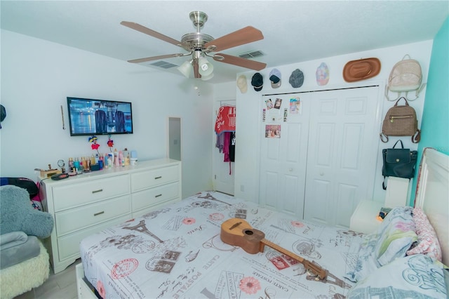 bedroom with visible vents, a closet, and ceiling fan