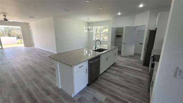 kitchen with white cabinets, plenty of natural light, stainless steel appliances, and a sink